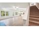 Bright living room showing stairs, an open layout and view of the outdoor scenery at 11850 Rizvan Pl, Covington, GA 30014