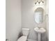Neat powder room including a pedestal sink, brushed fixtures, and neutral paint at 11850 Rizvan Pl, Covington, GA 30014