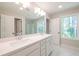 Bright bathroom featuring a double vanity with quartz countertops and ample lighting at 1624 Ruskin Way, Marietta, GA 30062