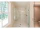 Modern glass shower with marble-look tile and a built-in seat at 1624 Ruskin Way, Marietta, GA 30062