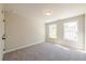 Bedroom with neutral walls, carpeted floors, and natural light from the two windows at 1624 Ruskin Way, Marietta, GA 30062