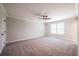 Spacious bedroom with carpeted floors, ceiling fan, and window at 1624 Ruskin Way, Marietta, GA 30062