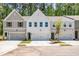 Charming townhome exterior featuring a manicured lawn, attached garage, and a welcoming facade at 1624 Ruskin Way, Marietta, GA 30062