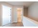 Hallway with hardwood flooring, leading to bathroom and carpeted bedroom at 1624 Ruskin Way, Marietta, GA 30062