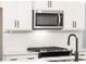 Modern kitchen featuring stainless steel appliances, white cabinetry, and sleek countertops at 1624 Ruskin Way, Marietta, GA 30062