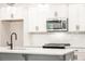 Kitchen featuring stainless steel microwave, white cabinets and quartz countertops at 1624 Ruskin Way, Marietta, GA 30062