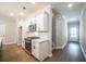 Kitchen area with stainless steel appliances, white cabinetry, and hardwood floors at 1624 Ruskin Way, Marietta, GA 30062