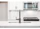 Close-up of kitchen featuring modern sink, stainless steel microwave, and gas range at 1624 Ruskin Way, Marietta, GA 30062