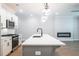 Bright kitchen with island, pendant lighting, stainless appliances, and an adjacent living area at 1624 Ruskin Way, Marietta, GA 30062
