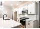 Modern kitchen with white cabinetry, stainless steel appliances, and a stylish countertop at 1624 Ruskin Way, Marietta, GA 30062