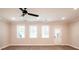 Open living room with hardwood floors, recessed lights, and large windows at 1624 Ruskin Way, Marietta, GA 30062