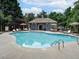 A bright community pool featuring lounge chairs and surrounding trees at 1624 Ruskin Way, Marietta, GA 30062