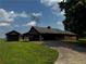 Cozy, single-story home with a dark roof and siding, complemented by a lush green lawn and long driveway at 3105 Hamilton Mill Rd, Buford, GA 30519