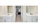 Dual vanities in the large primary bathroom lead into a carpeted bedroom at 42 Citrine Way, Acworth, GA 30101