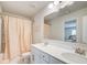Bathroom featuring double sinks, a large mirror, and a shower with a pink curtain at 42 Citrine Way, Acworth, GA 30101