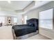Well-lit bedroom boasts tray ceilings and a plush bed, creating a relaxing retreat at 42 Citrine Way, Acworth, GA 30101