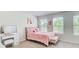 Bright bedroom featuring a pink bed frame and linens, vanity, and lots of natural light at 42 Citrine Way, Acworth, GA 30101