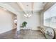 Open-concept dining room with modern chandelier, wood floors, and decorative mirrors at 42 Citrine Way, Acworth, GA 30101