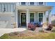 Inviting front porch with seating, decorative wreath, and manicured landscaping at 42 Citrine Way, Acworth, GA 30101