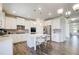 Modern kitchen with white cabinets, stainless steel appliances, and a center island with seating at 42 Citrine Way, Acworth, GA 30101