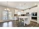 Modern white kitchen with stainless appliances, center island and access to patio area at 42 Citrine Way, Acworth, GA 30101