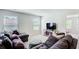 Comfortable living room featuring a plush sectional sofa, ottoman, and a modern entertainment setup at 42 Citrine Way, Acworth, GA 30101