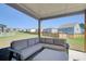 Inviting covered patio with comfortable seating, perfect for outdoor relaxation and entertaining with fenced yard at 42 Citrine Way, Acworth, GA 30101