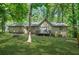 Backyard view of home with a small deck perfect for outdoor enjoyment and serene nature views at 5837 Fox Run, Rex, GA 30273