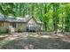 Backyard view of home with a small deck perfect for outdoor enjoyment and serene nature views at 5837 Fox Run, Rex, GA 30273