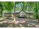 Backyard view of home with a small deck perfect for outdoor enjoyment and serene nature views at 5837 Fox Run, Rex, GA 30273