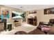 Basement living area with a large television, wine rack, leather seating, and wall art at 5837 Fox Run, Rex, GA 30273