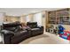 Basement with comfortable seating and a shelving unit filled with collectibles and other items at 5837 Fox Run, Rex, GA 30273