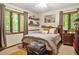 Comfortable bedroom featuring a large window with a view, a full bed, and hardwood floors at 5837 Fox Run, Rex, GA 30273