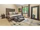 Spacious bedroom with a large window, neutral tones, and a comfortable seating area at 5837 Fox Run, Rex, GA 30273