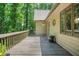 Spacious wooden deck with railing overlooks lush greenery, offering an inviting outdoor living space at 5837 Fox Run, Rex, GA 30273