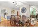 Dining room featuring hardwood floor, a dining set, a clock, and living room and kitchen view at 5837 Fox Run, Rex, GA 30273