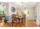 Hardwood dining room with chandelier, dining set, a large analog clock, and living area visible at 5837 Fox Run, Rex, GA 30273