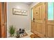 Welcoming entryway featuring a wooden door, tile flooring, and closet space at 5837 Fox Run, Rex, GA 30273
