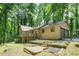 Charming home with a deck, two-car garage, and a well-maintained yard surrounded by lush greenery at 5837 Fox Run, Rex, GA 30273
