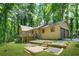 Charming home with a deck, two-car garage, and a well-maintained yard surrounded by lush greenery at 5837 Fox Run, Rex, GA 30273