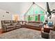 Open-concept living room featuring a vaulted ceiling, hardwood floors, and an abundance of natural light at 5837 Fox Run, Rex, GA 30273