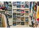 Organized walk-in closet featuring a closet system with multiple shelves filled with clothing at 5837 Fox Run, Rex, GA 30273