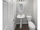 Bathroom features pedestal sink, toilet, and modern lighting at 105 Odyssey Turn, Conyers, GA 30012