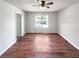 Bedroom with wood-look floors, ceiling fan, and natural light creating a relaxing atmosphere at 105 Odyssey Turn, Conyers, GA 30012
