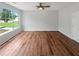 Bedroom features wood-look floors, ceiling fan, and natural light creating a relaxing atmosphere at 105 Odyssey Turn, Conyers, GA 30012