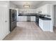 Bright kitchen with stainless steel appliances, white cabinetry, and dark countertops offers a modern design at 105 Odyssey Turn, Conyers, GA 30012