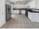 Bright kitchen with stainless steel appliances, white cabinetry, and dark countertops offers a modern design at 105 Odyssey Turn, Conyers, GA 30012