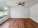 Bright living room featuring wood-look flooring and large windows at 105 Odyssey Turn, Conyers, GA 30012