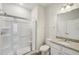 Bathroom featuring a vanity with granite countertop and a glass-enclosed shower at 11854 Rizvan Pl, Covington, GA 30014