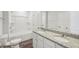 Modern bathroom featuring granite countertops, double sinks, and a shower-tub combo at 11854 Rizvan Pl, Covington, GA 30014